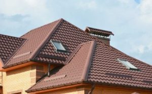 Multi-story home with a red tile roof. 