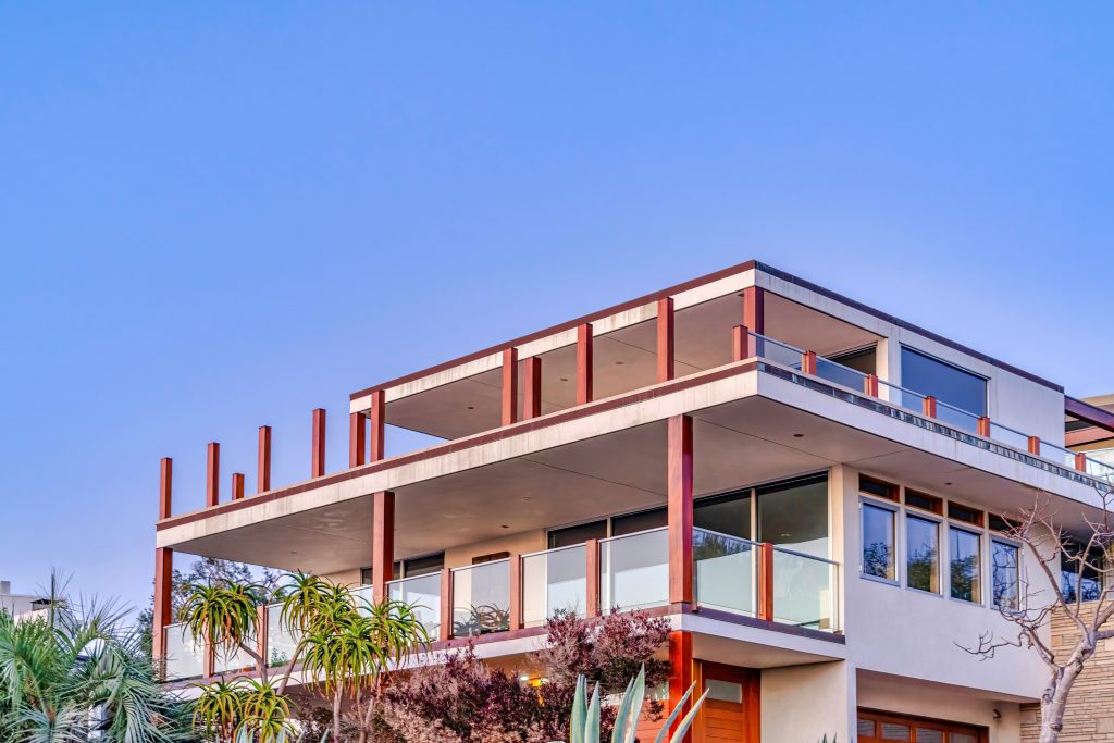 Modern three storey house with balconies and flat roof 