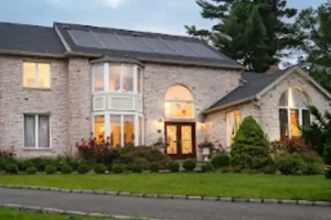 Two-story home with a dark roof and Timberline solar shingles.