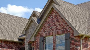 Red brick residential property with light grey roof.