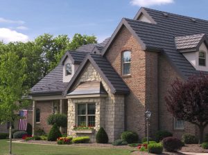 Multi-story home with brick siding and a gray roof.