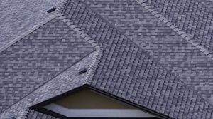 Large home with grey asphalt shingles installed.